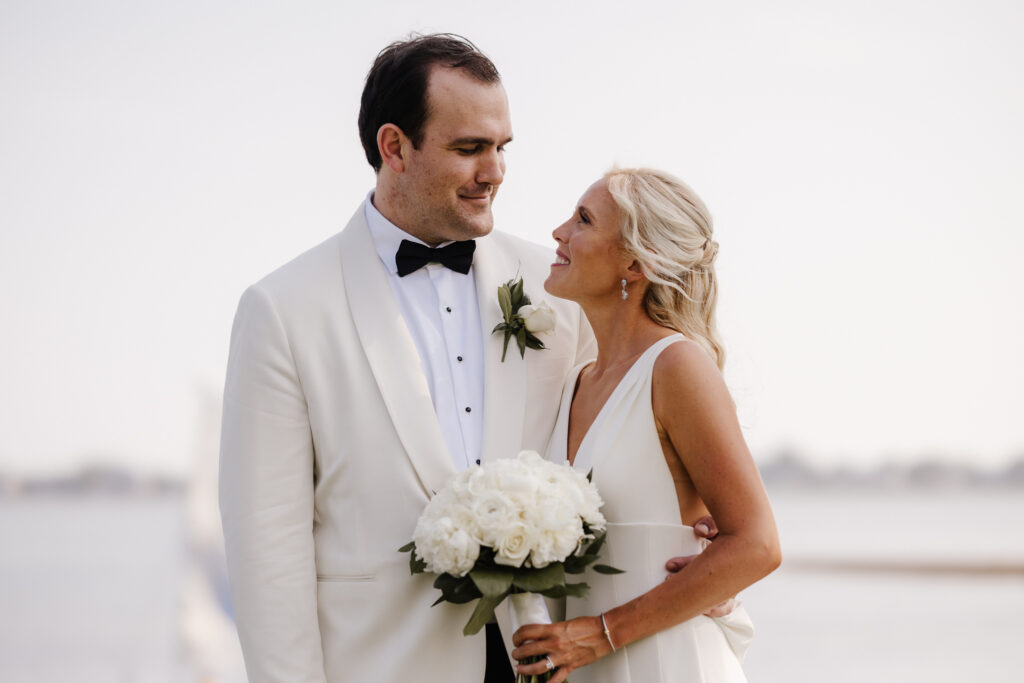 Couple sharing a quiet moment by the water on their wedding day, elegant portrait by Honey & Bloom Photography