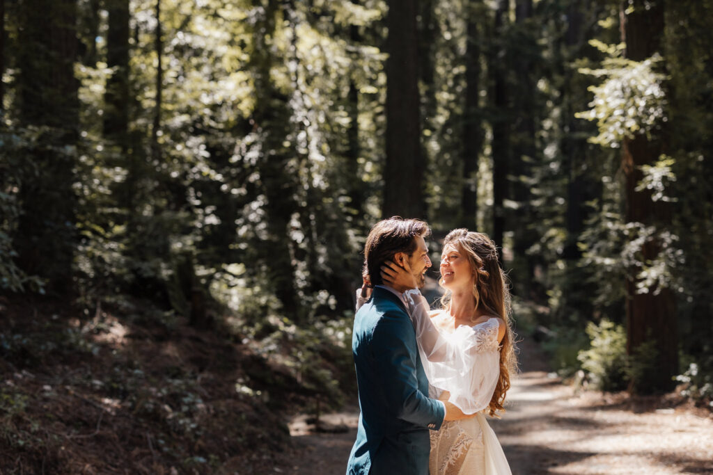 Couple sharing a quiet moment together in a sunlit forest on their wedding day, intimate portrait by Honey & Bloom Photography
