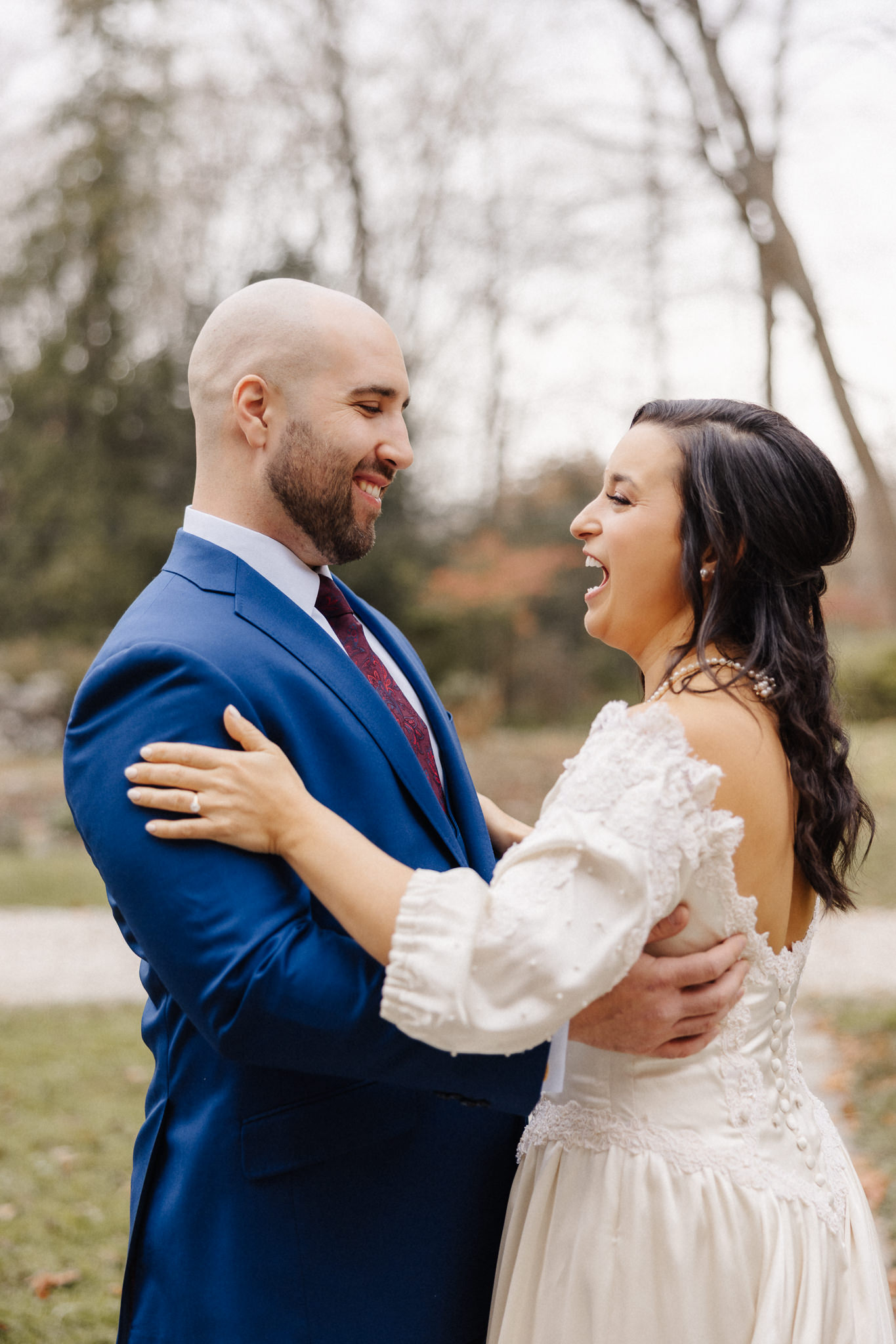 Couple laughing together outdoors on their wedding day, documentary-first wedding photography by Honey and Bloom Photography Central New York