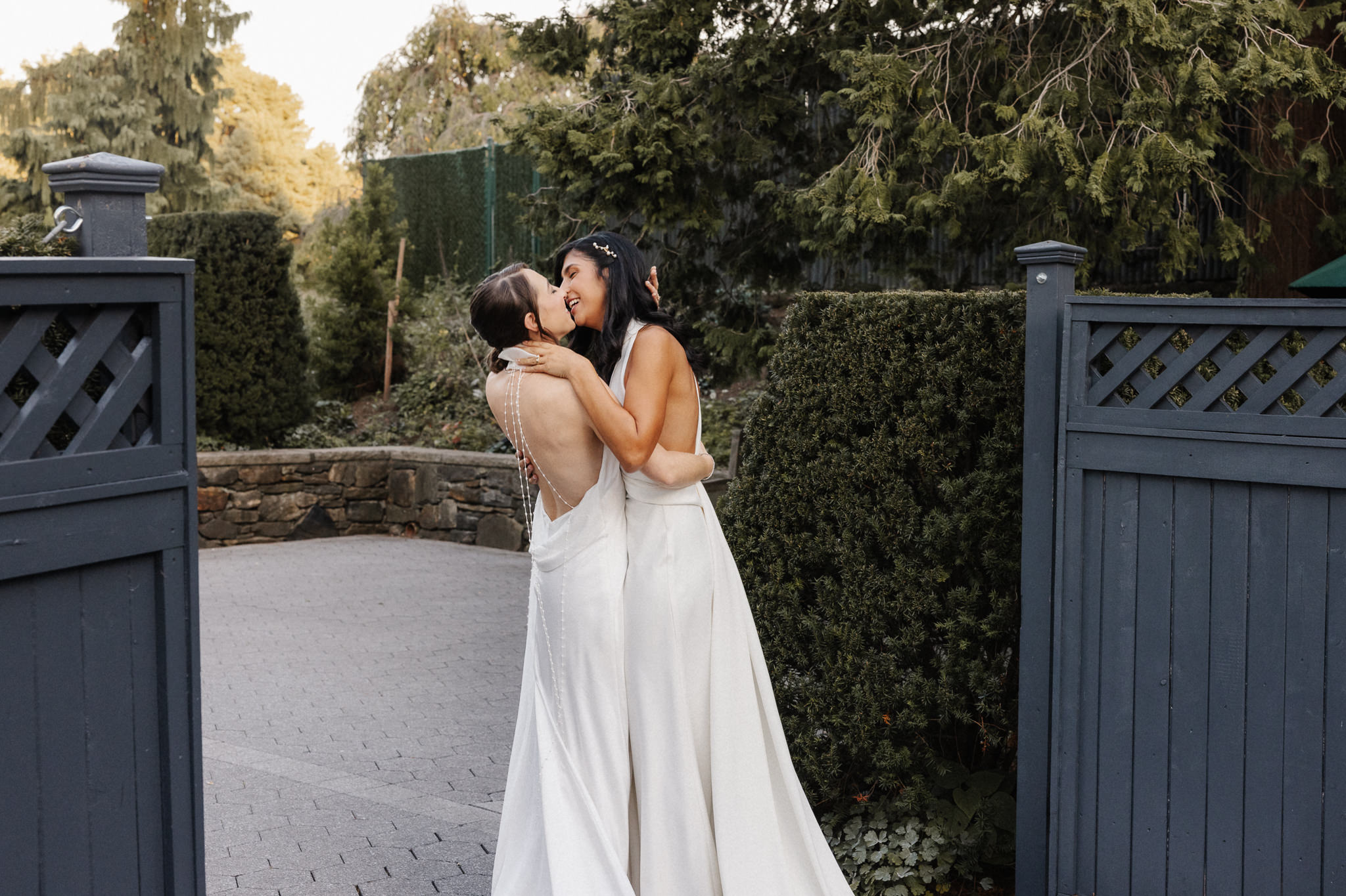 Couple kissing in golden hour light on their wedding day, photographed by an Upstate New York wedding photographer at Honey and Bloom Photography