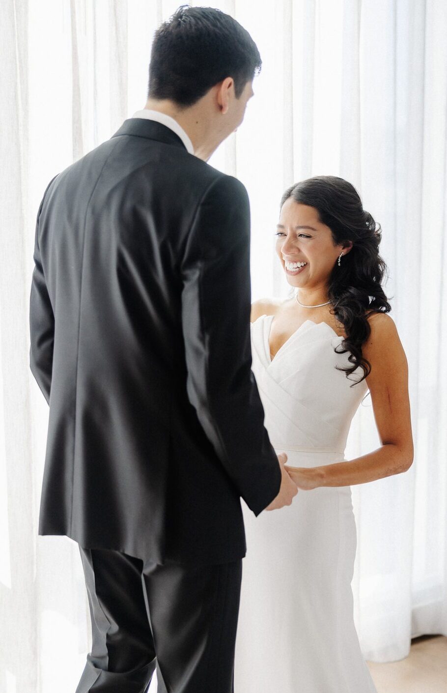 Bride laughing with joy at her first look, presence over perfection wedding photography by Honey and Bloom Photography.